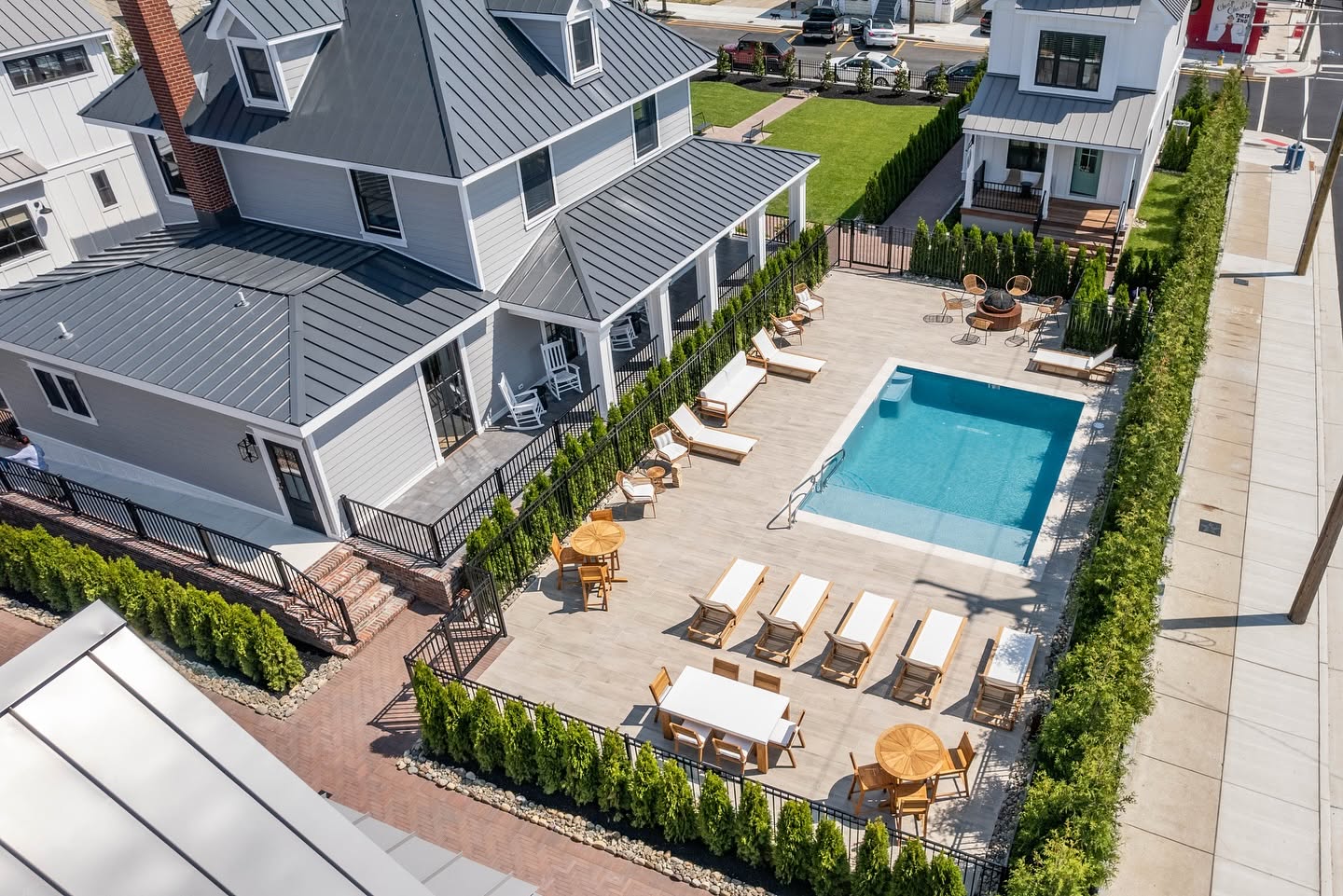 Aerial view of The Hen Houses showing the outdoor pool, lounge chairs, and beach houses